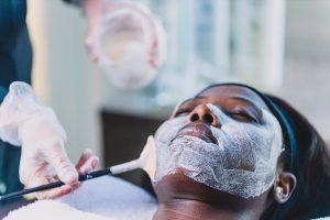 A young black woman gets a chemical peel at a medi spa