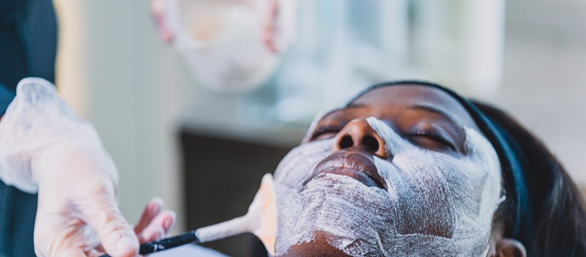 A young black woman gets a chemical peel at a medi spa