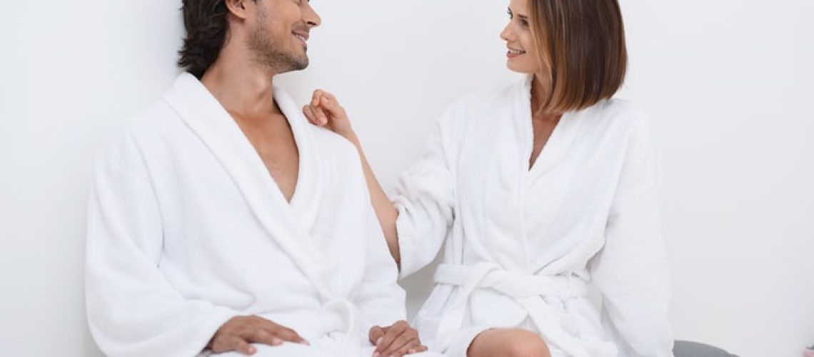 It is our time in spa. Close up of lovely adult couple spending time in spa, sitting and waiting for treatments, looking at each other