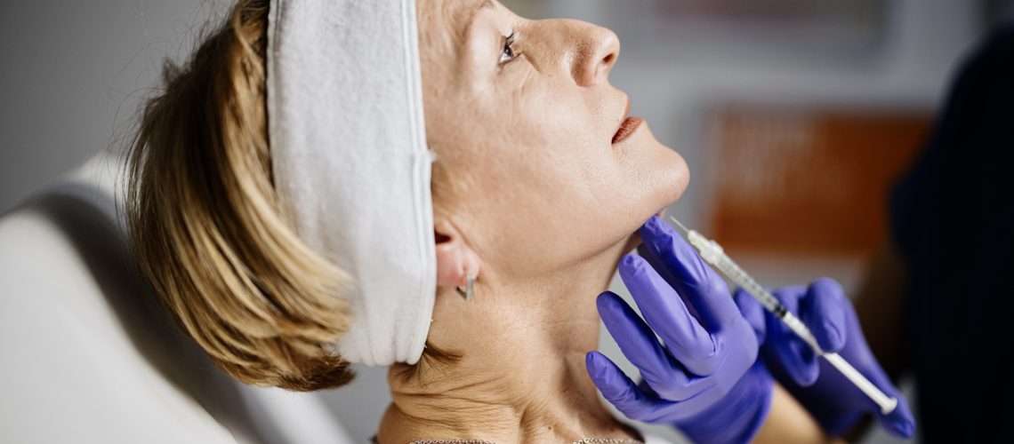 Female doctor performing non-invasive double chin removal without a scalpel
